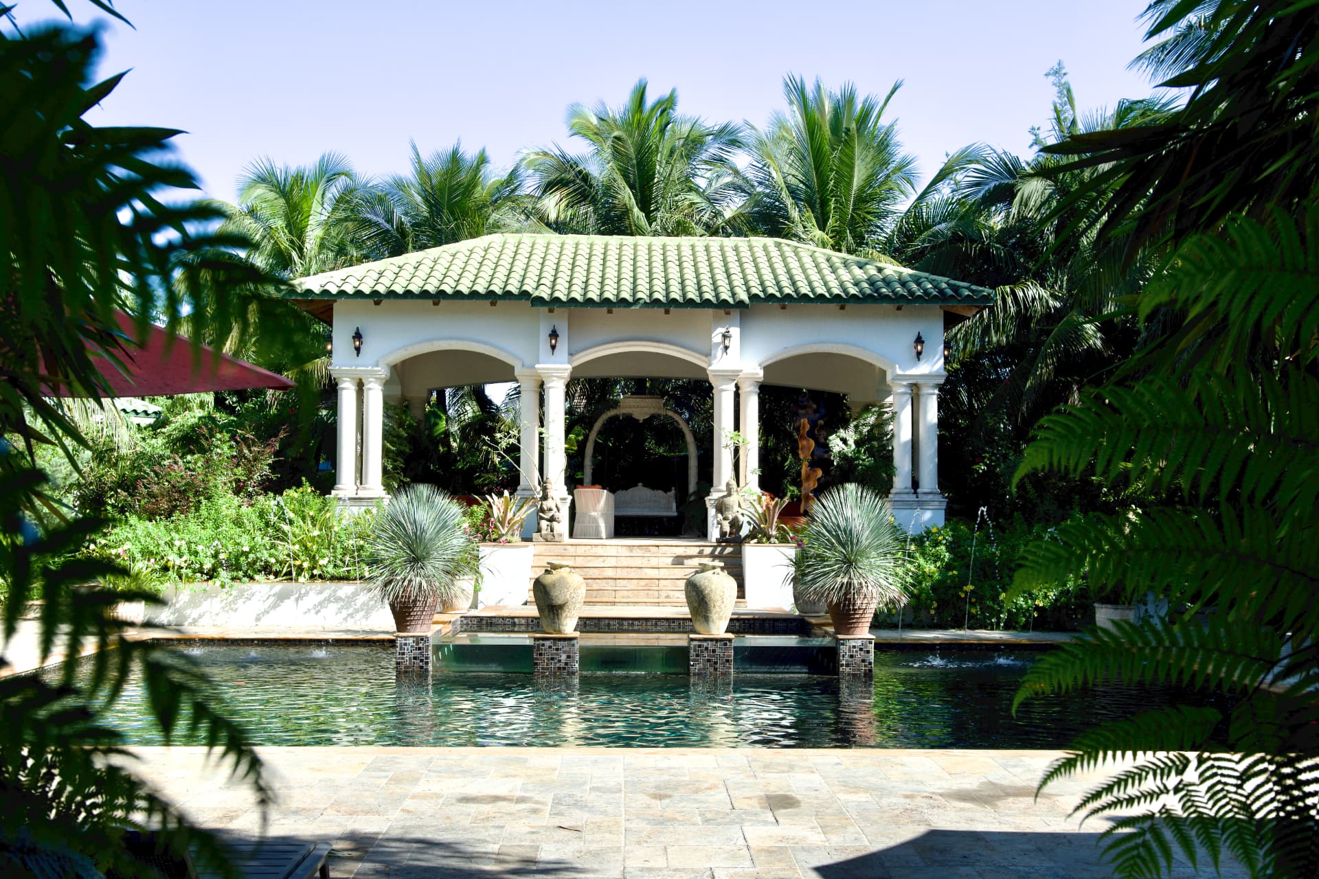 Wooden meditation deck beside a water feature in the botanical sanctuary